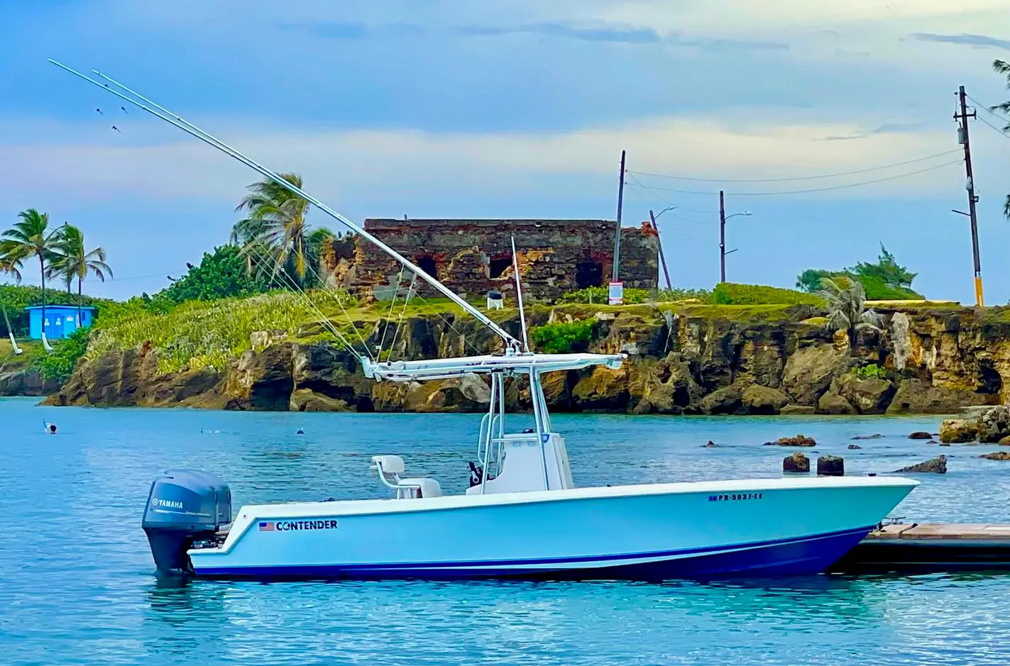 Contender center console fishing boat docked near the historic fort ruins on San Juan Bay